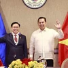 Председатель Национального собрания Выонг Динь Хюэ (слева) и спикер Палаты представителей Филиппин Мартин Ромуальдес в Маниле 23 ноября. (Фото: ВИА)