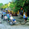 Туристы посещают древний город Хойан на велорикше. (Фото: ВИА)