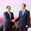 Премьер-министр Фам Минь Тьинь (слева) и президент Джоко Видодо на встрече в кулуарах 42-го саммита АСЕАН и связанных с ним встреч в Индонезии в мае прошлого года. (Фото: ВИА)
