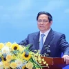 Премьер-министр Фам Минь Тьинь выступает на гибридной конференции, проходящей в Ханое 8 января, чтобы оценить работу Petrovietnam в 2023 году и наметить задачи на этот год. (Фото: ВИA)