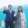 Премьер-министр Фам Минь Тьинь и его супруга Ле Тхи Бить Чан. (Фото: ВИA)