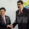 越南政府副总理兼外长范平明（左）与委内瑞拉总统尼古拉斯·马杜罗（右）（图片来源：越通社）