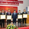 郑廷勇向老挝公共工程与运输部集体与个人授予独立勋章（图片来源：越通社）
