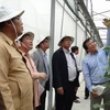 老挝占巴塞省省委书记兼省长本通•迪维塞率团访问胡志明市高科技农业园区
