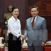 越南祖国阵线中央委员会副主席张氏玉映女士与老挝建国阵线中央主席赛宋蓬·丰威汉亲切握手。