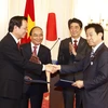 越南政府总理阮春福与日本首相安倍晋三见证越日各项合作文件签署仪式。（图片来源：越通社）