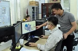 Engineers of Tomeco company in Hanoi's Ngoc Liep Industrial Cluster discuss industrial fan design (Photo: VNA)