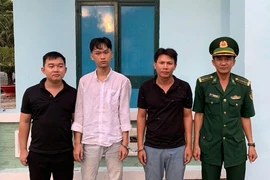 The three men (left) are arrested while attempting to exit Vietnam illegally. (Photo: VNA)