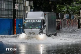 A road in Quezon province, the Philippines, is flooded following a storm in October 2024. (Photo: Xinhua/VNA)