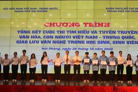 El comité organizador entrega obsequios a los estudiantes con excelentes logros académicos vietnamitas y chinas en Hai Phong. (Fuente: VNA)