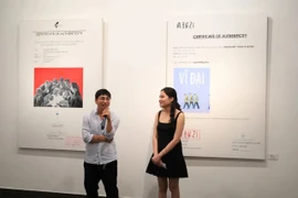 Artist Quach Bac and curator Hoang Minh Chau at the exhibiton opening. (Photo: vtv.vn)