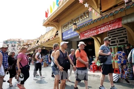 Foreigners visiting Binh Tay Market, home to exquisite architecture in Ho Chi Minh City. (Photo: VNA)