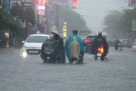 A heavy rain causes a wash out of a section of local road in the northern city of Hai Phong in June. (Photo: VNA)