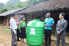 One of the 456 plastic water storage tanks is presented to a local in Cao Bang (Photo: VNA)