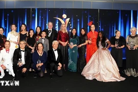 Deputy Ambassador of Vietnam to the UK To Minh Thu (in blue Ao Dai) takes a photo with the award winners. (Photo: VNA)