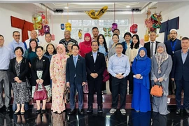 Participants at the workshop pose for group photo (Photo: VNA)