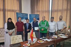 Vietnamese Ambassador to Algeria Tran Quoc Khanh (third from left) and representatives of several firms in Biskra. (Photo: VNA)