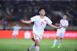 Nguyen Hai Long (24) celebrates his opener against Laos. (Photo: VNA)