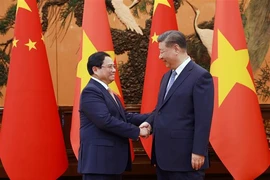  越南政府总理范明政会见中共中央总书记、中国国家主席习近平。图自越通社