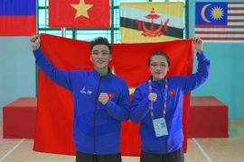 Pencak Silat athletes - Hoang Linh Dan (right) and Nguyen Thanh Long - win two gold medals in Seni events (performance) at the ongoing 13th ASEAN School Games (ASG) in the central city of Da Nang. (Photo: VNA)