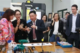 Parliamentary State Secretary to the Federal Ministry for Economic Cooperation and Development of Germany Bärbel Kofler ( first, left) is introduced to vocational training at LILAMA 2. (Photo: VNA)