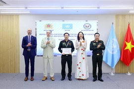 A police officer receives a certificate after attending the training programme in Hanoi. (Photo: VNA)