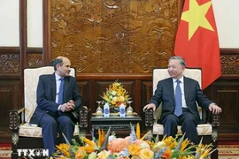 President To Lam (right) receives Indian Ambassador to Vietnam Sandeep Arya in Hanoi on June 26 (Photo: VNA)