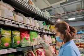 A local is buying rice at stabilised price at a supermarket in HCM City. (Photo: VNA)