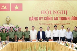 Слева направо: Президент государства То Лам (5), премьер-министр Фам Минь Тьинь (6) и другие делегаты позируют для группового фото на мероприятии. (Фото: ВИA)