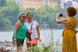 Des touristes visitent le lac Hoàn Kiêm, au coeur de Hanoi. Photo : VNA