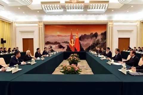 The meeting between the CPV delegation and Wang Huning, member of the Standing Committee of the CPC Central Committee’s Political Bureau and Chairman of the National Committee of the Chinese People’s National Political Consultative Conference, in Beijing on June 13 (Photo: VNA)