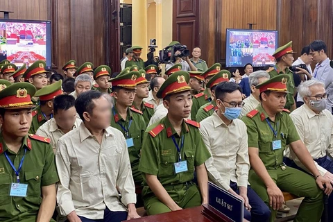 Defendants involved in the Vietnam Register corruption case at the first-instance trial opened in HCM City on July 18. (Photo: VNA)