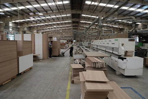 Wooden goods are made for export at a factory in Long An province. (Photo: VNA)