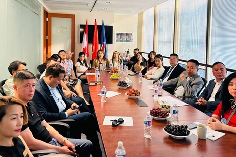 Delegates attend the VCBA's second congress via videoconference at the Vietnamese Consulate General in Vancouver city. (Photo: VNA)