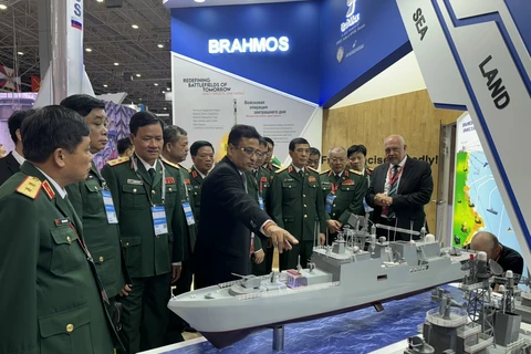 Vietnamese Minister of National Defence Gen. Phan Van Giang (front, third from right) and other officials visit a booth at Army-2024 on August 12. (Photo: VNA)