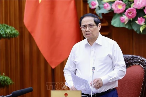 PM Pham Minh Chinh speaks at the meeting between permanent Government members and representatives of ministries and sectors on August 16. (Photo: VNA)