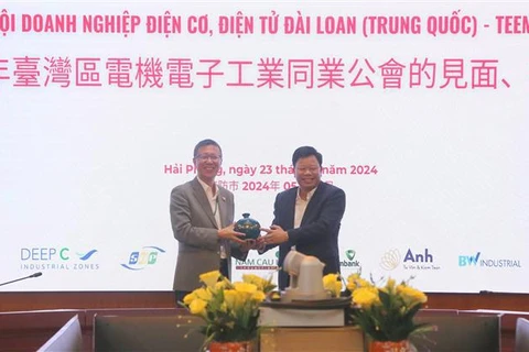 Le directeur du comité de gestion de la zone économique de Hai Phong, Le Trung Kien (droite), offre un cadeau au représentant de la délégation de TEEMA. Photo: VNA 