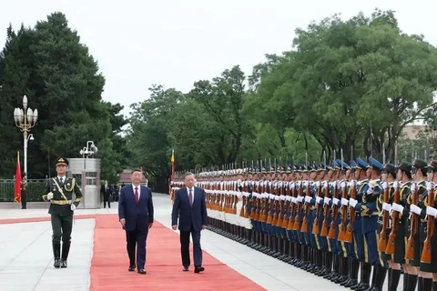 El secretario general del Partido Comunista de Vietnam y presidente del país, To Lam (derecha), y el secretario general del Partido Comunista y presidente de China, Xi Jinping, en el acto de bienvenida. (Foto: VNA)