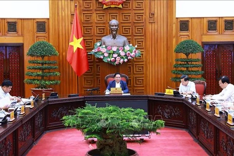 政府总理范明政主持召开会议。图自越通社