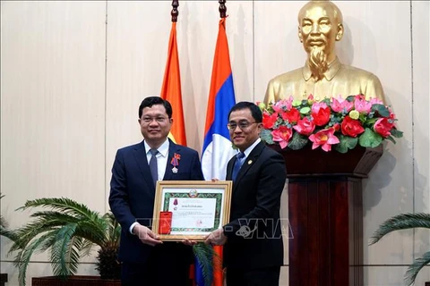 老挝塞公省委书记兼省长Leklay Sivilay向向越南岘港市人民议会常务副主席陈福山授予老挝人民民主共和国三等自由勋章。图自越通社