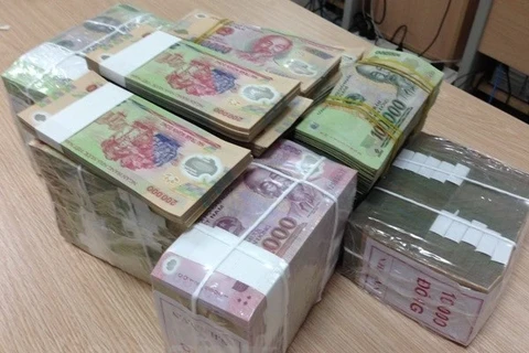 The State Bank of Vietnam sets the daily reference exchange rate at 24,261 VND/USD on July 22 (Photo: VNA)