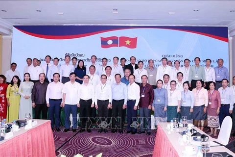 HCM City and Lao participants of the meeting pose for a group photo (Source: VNA)