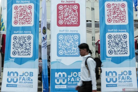 A jobseeker passing by banners imbued with QR codes of overseas job vacancies during a job fair in Sukabumi City, West Java, on August 29, 2024. (Photo: ANTARA FOTO/Henry Purba/agr/rwa)