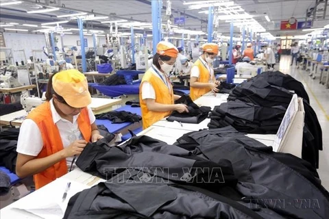 Garment production at a shirt and suit factory of May 10 Corporation in Sai Dong, Long Bien district, Hanoi. (Photo: VNA)