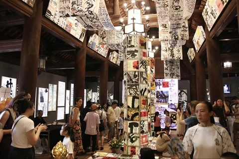 Artworks of calligraphy integrated with light technology are displayed at the Temple of Literature in Hà Nội. (Photo: Courtesy of the Temple of Literature) 