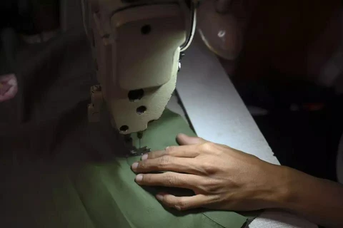  A worker works on a piece of clothing at a small-scale manufacturing in South Jakarta on September 30. (Photo: Antara)