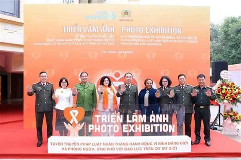 Participants at the opening of the photo exhibition in Hanoi on November 27. (Photo: VNA)