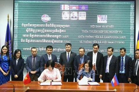 VNA General Director Vu Viet Trang and AKP Director General Sokmom Nimul sign a renewed cooperation agreement between the two national news agencies. (Photo: VNA)