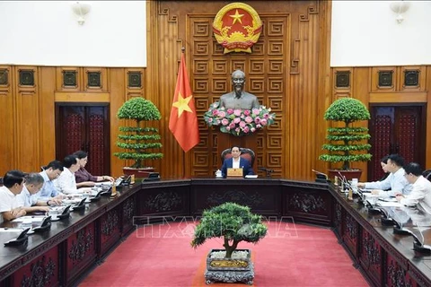 Prime Minister Pham Minh Chinh chairs a meeting on the monetary policy with leaders of the State Bank of Vietnam (SBV), the Ministry of Finance, the Ministry of Planning and Investment, and other ministries and agencies. (Photo: VNA)