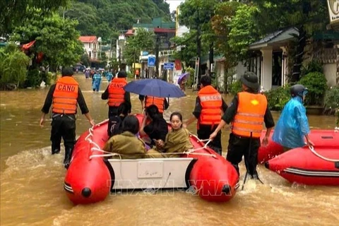 People are evacuated from flooded areas in the northern province of Ha Giang. (Photo: VNA)